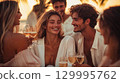 Friends sharing a celebratory toast with wine during a beautiful sunset. A group of elegant people enjoys a happy toast with wine glasses on a warm evening. This is AI-generated item 129995762