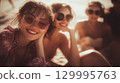 Three happy friends on a beach vacation, smiling and enjoying the sun A group of happy young women enjoying a sunny day at the beach, This is AI-generated item 129995763