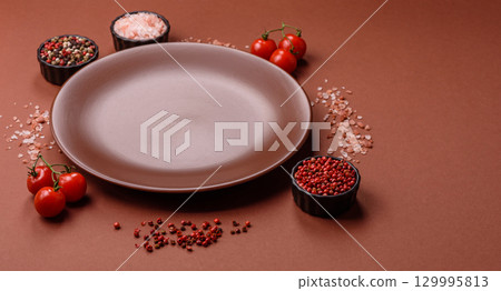 Empty ceramic plate on a monochrome brown background Empty ceramic plate on a monochrome brown background 129995813