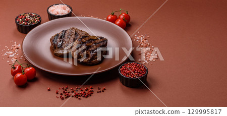 Grilled beef steak meat with salt and pepper. Beef steak grilled on a barbecue Grilled beef steak meat with salt and pepper. Beef steak grilled on a barbecue 129995817