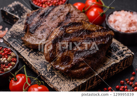 Grilled beef steak meat with salt and pepper. Beef steak grilled on a barbecue 129995839