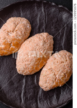 Steamed fish or chicken cutlets or meatballs with salt and spices. Fish cutlets 129995876
