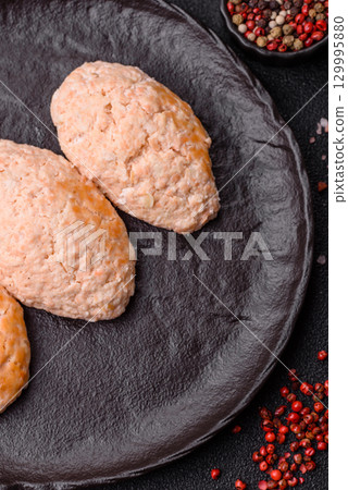 Steamed fish or chicken cutlets or meatballs with salt and spices. Fish cutlets 129995880