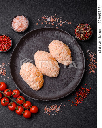 Steamed fish or chicken cutlets or meatballs with salt and spices. Fish cutlets 129995884