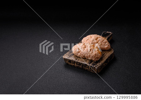 Steamed fish or chicken cutlets or meatballs with salt and spices. Fish cutlets 129995886