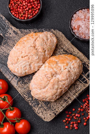 Steamed fish or chicken cutlets or meatballs with salt and spices. Fish cutlets 129995896