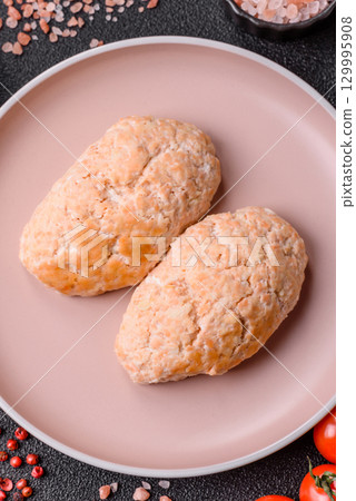 Steamed fish or chicken cutlets or meatballs with salt and spices. Fish cutlets 129995908