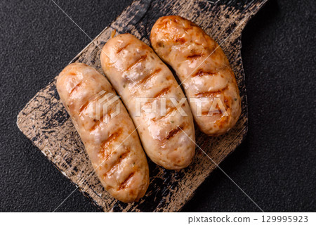 Grilled chicken or beef sausages, a hot meat dish. Barbecued sausages 129995923