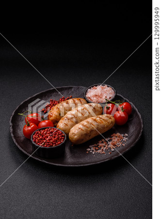 Grilled chicken or beef sausages, a hot meat dish. Barbecued sausages 129995949