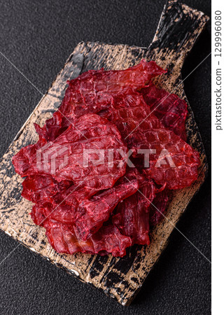 Jerky or dried chicken and cherry snacks. Dehydrated, dried snacks for beer Jerky or dried chicken and cherry snacks. Dehydrated, dried snacks for beer 129996080