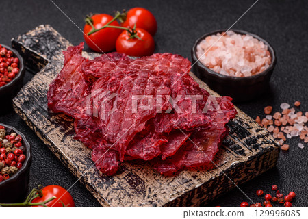 Jerky or dried chicken and cherry snacks. Dehydrated, dried snacks for beer 129996085