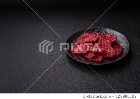 Jerky or dried chicken and cherry snacks. Dehydrated, dried snacks for beer 129996102