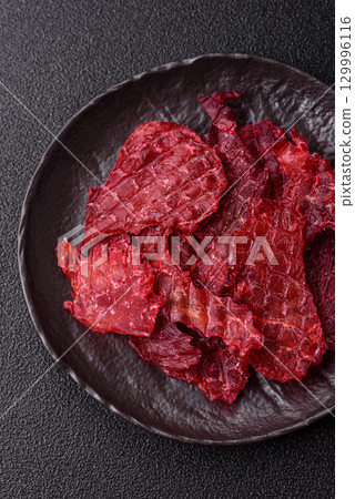 Jerky or dried chicken and cherry snacks. Dehydrated, dried snacks for beer Jerky or dried chicken and cherry snacks. Dehydrated, dried snacks for beer 129996116