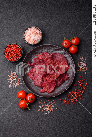 Jerky or dried chicken and cherry snacks. Dehydrated, dried snacks for beer 129996132