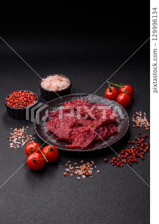 Jerky or dried chicken and cherry snacks. Dehydrated, dried snacks for beer 129996134