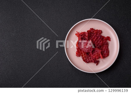 Jerky or dried chicken and cherry snacks. Dehydrated, dried snacks for beer 129996139