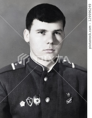 Vintage portrait of a young corporal of the Soviet army. Retro photo 1968 129996249