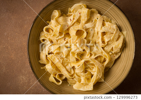 Fettuccine, tagliatelle, in creamy garlic sauce, Italian traditional cuisine, pasta carbonaro, Fettuccine, tagliatelle, in creamy garlic sauce, Italian traditional cuisine, pasta carbonaro, 129996273