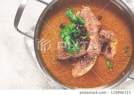 fesenjan, an Iranian dish, stewed chicken, in a nut-pomegranate sauce, in a saucepan,light background, homemade, no people, 129996315