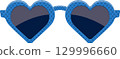 Heart-shaped eyewear with a blue, polka-dotted frame and dark lenses that reflect light attractively. 129996660