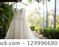 beautiful wedding dress hanging on the hanger 129996680