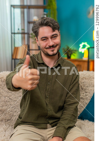 Middle-aged man thumbs up smiling showing positive ok feedback happy approval gesture satisfied like 129996762