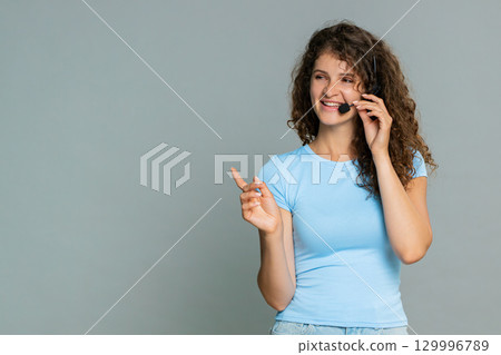 Woman pretending talking in microphone presenting host operator broadcaster playful speech reaction Woman pretending talking in microphone presenting host operator broadcaster playful speech reaction 129996789