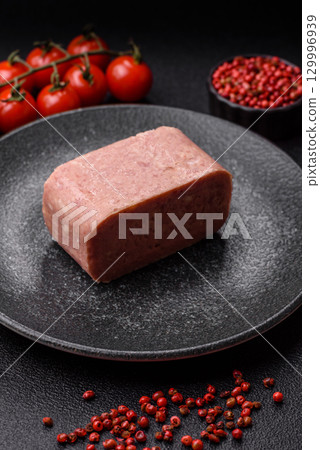 Food, meat, ham sliced in slices for the festive table. Spiced ham 129996939