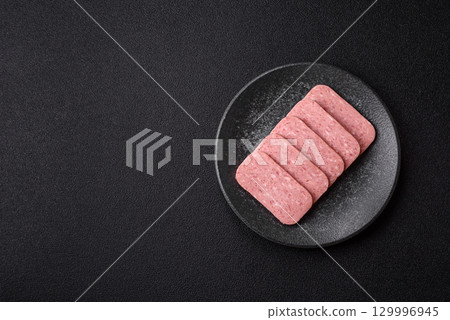 Food, meat, ham sliced in slices for the festive table. Spiced ham 129996945