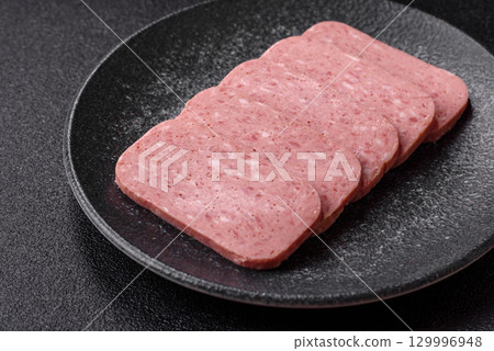 Food, meat, ham sliced in slices for the festive table. Spiced ham 129996948