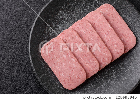 Food, meat, ham sliced in slices for the festive table. Spiced ham 129996949