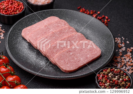 Food, meat, ham sliced in slices for the festive table. Spiced ham 129996952