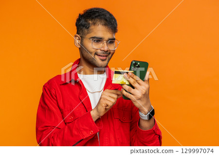 Man use credit bank card smartphone while transferring spending money, purchases online shopping 129997074