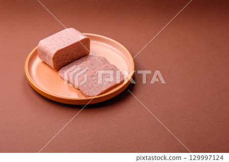 Food, meat, ham sliced in slices for the festive table. Spiced ham 129997124