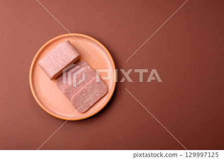 Food, meat, ham sliced in slices for the festive table. Spiced ham 129997125