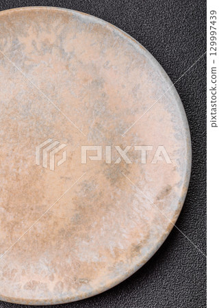 Empty round black plate for food, kitchen utensils on dining table. Empty plate Empty round black plate for food, kitchen utensils on dining table. Empty plate 129997439