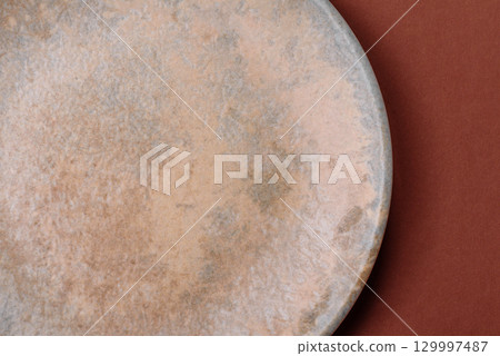 Empty round black plate for food, kitchen utensils on dining table. Empty plate 129997487