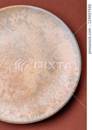 Empty round black plate for food, kitchen utensils on dining table. Empty plate Empty round black plate for food, kitchen utensils on dining table. Empty plate 129997488