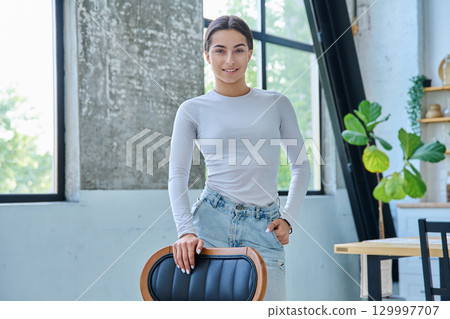 Portrait of beautiful stylish young teenage girl posing at home Portrait of beautiful stylish young teenage girl posing at home 129997707