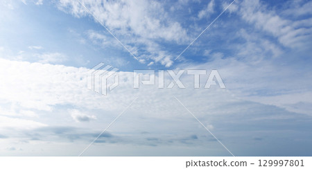 Bright Blue Sky with Wispy Clouds on a Clear Day 129997801