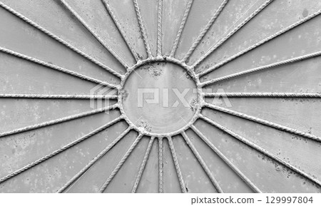 A detailed view of a radial metal design with gray rust texture 129997804