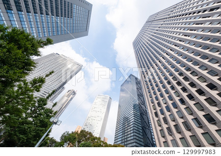 A view of an office district with street trees and skyscrapers 129997983
