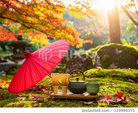 Tea ceremony utensils and a Japanese umbrella illuminated by autumn light: a beautiful Japanese tradition 129998355