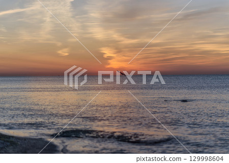 A sunset over a body of water 129998604