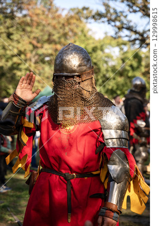 a man in medieval armor. 129998615