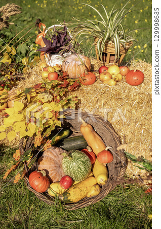 A group of fruit and vegetables on display 129998685