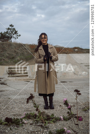 young girl on the seashore around the rocks young girl on the seashore around the rocks 129998781