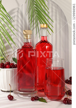 Homemade strong cherry cider in bottles and glasses on elegant background, still life with alcoholic drinks and fresh cherries, home winemaking concept, minimalist banner for bar, Homemade strong cherry cider in bottles and glasses on elegant background, still life with alcoholic drinks and fresh cherries, home winemaking concept, minimalist banner for bar, 129998961
