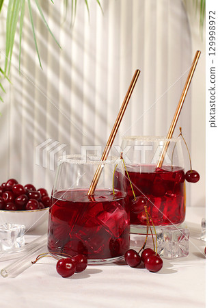 Refreshing homemade lemonade cocktail, mojito with cherry, mint, ice and lemon, weight loss concept,detox water with fruit flavor. Healthy and natural food,advertising for bar and cafe, autumn banner 129998972