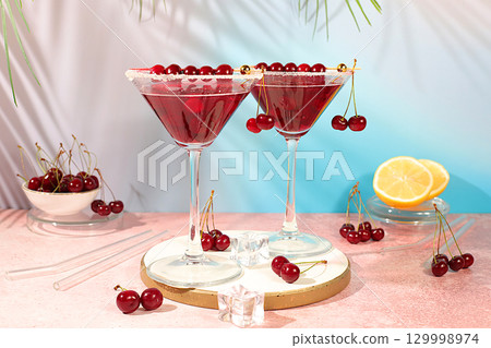 Margarita with cherry, mint, ice with tequila, vodka on elegant background, still life with drinks minimalist concept for bar, soft and alcoholic drink for weight loss, advertising banner for cafe Margarita with cherry, mint, ice with tequila, vodka on elegant background, still life with drinks minimalist concept for bar, soft and alcoholic drink for weight loss, advertising banner for cafe 129998974